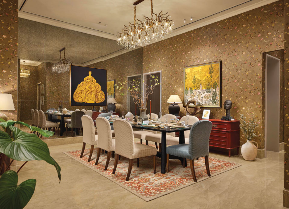 Dining room with an eight-seat table, crystal chandelier and artworks